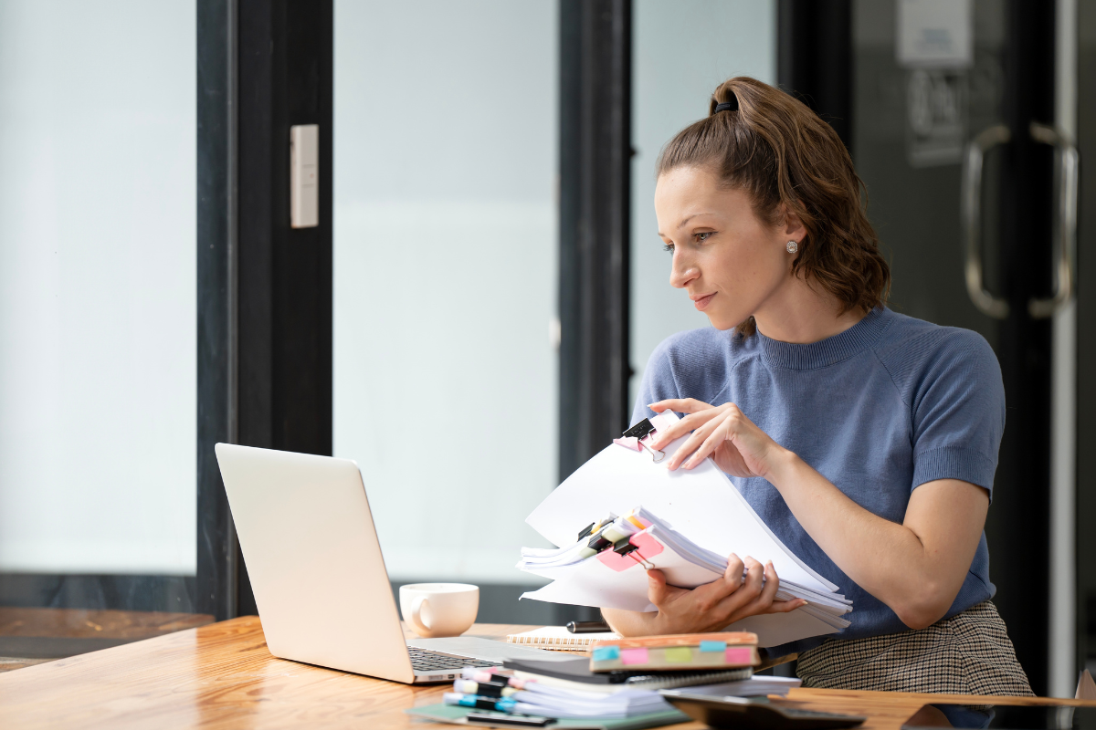 HR manager conducting process audit with checklist and documents showing how to run an HR process audit effectively