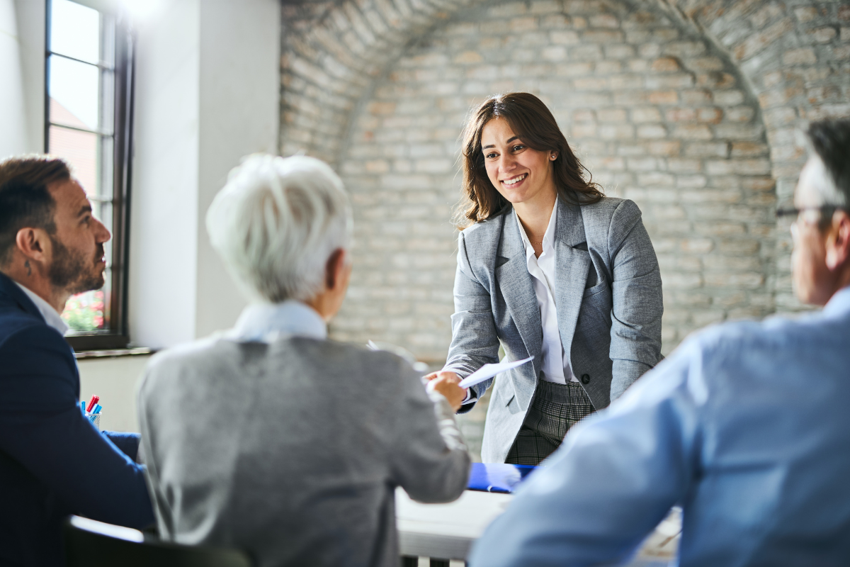 HR professionals analyzing Lean Six Sigma workflow charts and process improvement data on a conference room table